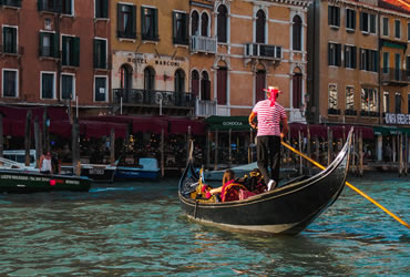 A gondolier with tourists in a Venetian canal