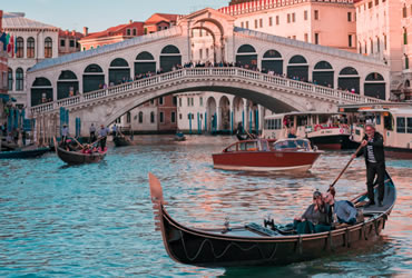 A gondolier with tourists in the Grand Canal of Venice