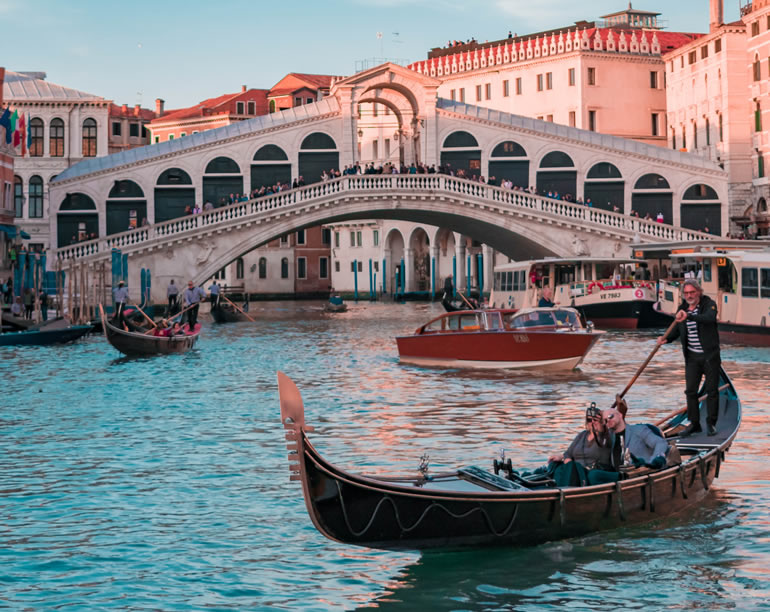 A gondolier with tourists in the Grand Canal of Venice